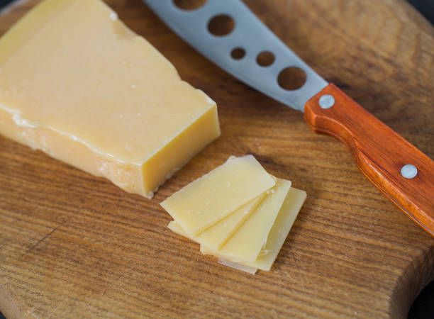 istock cheese knife with a wooden handle over black 1197165758