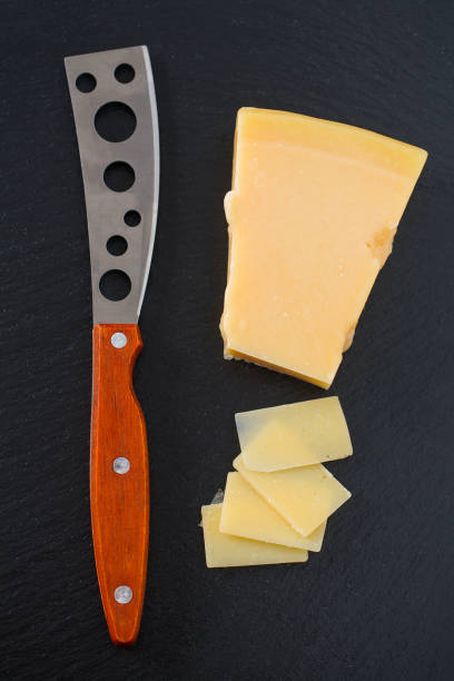 istock cheese knife with a wooden handle over black 1197165786