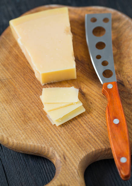 istock cheese knife with a wooden handle over black 1197165857