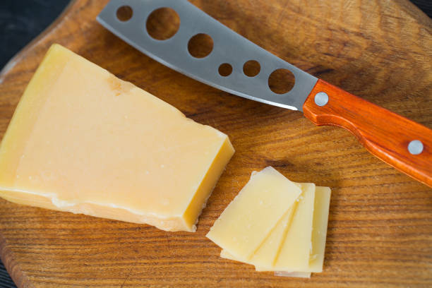 istock cheese knife with a wooden handle over black 1197165985