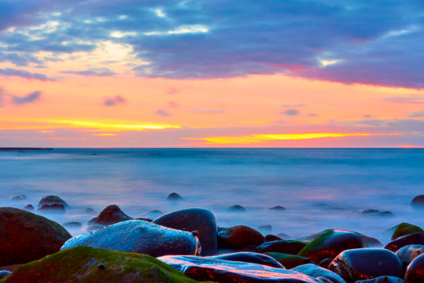 istock Sunset over the sea and stony beach 1197169370