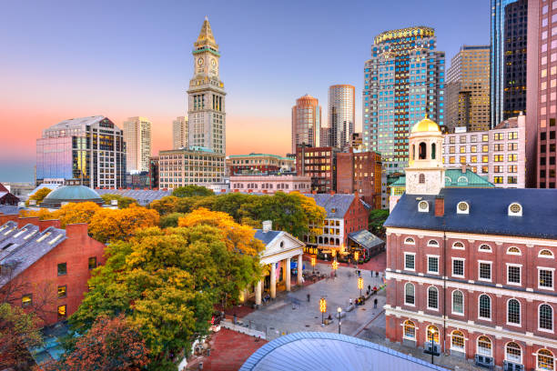 Boston, Massachusetts, USA Downtown Skyline Boston, Massachusetts, USA skyline with Faneuil Hall and Quincy Market at dusk. boston skyline night skyscraper stock pictures, royalty-free photos & images