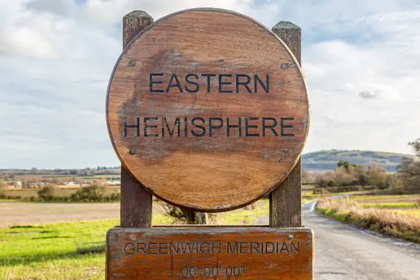 A sign marking the Greenwich  Meridian Line in the Sussex countryside
