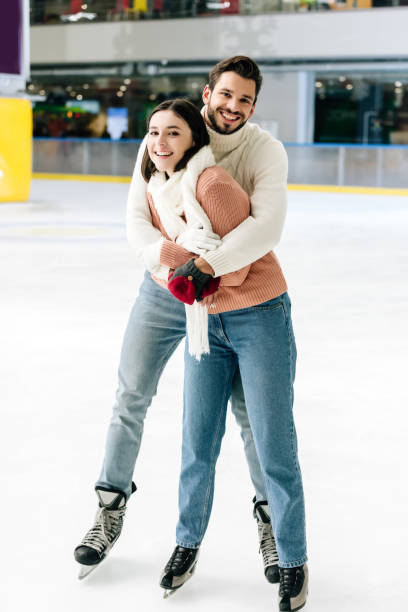 istock young cheerful couple hugging and spending time on skating rink 1197172467