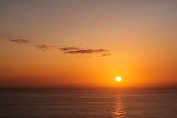 istock sun over ocean horizon, sunset sky over water - 1197175587
