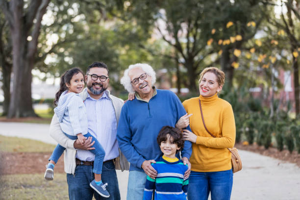 istock Three generation Hispanic family taking walk in park 1197181030
