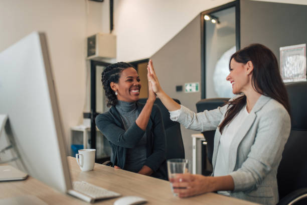 istock Two excited businesswoman high five in modern office. 1197182252
