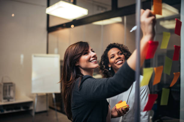 istock Cheerful co-workers brainstorming in modern office, portrait. 1197182262
