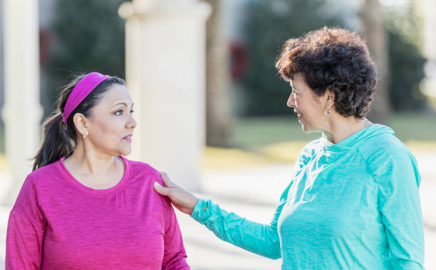 istock Two Hispanic women walking in park, talking 1197182553