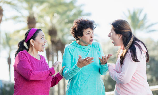 Three Hispanic women walking and talking in park