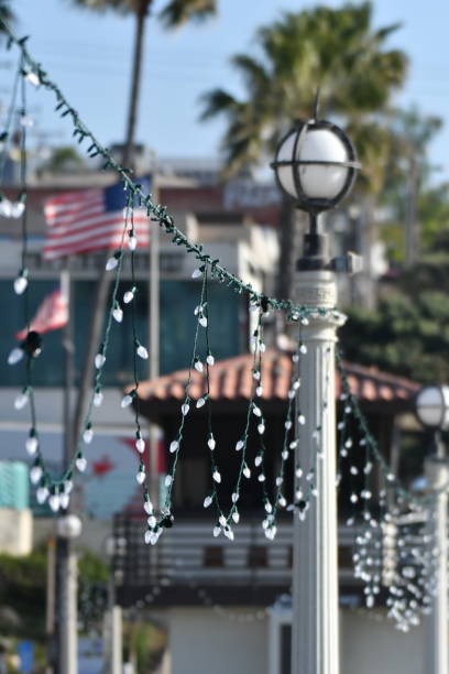 Christmas Lights on a Sunny Pier with Flags Manhattan Beach Pier steven harrie stock pictures, royalty-free photos & images