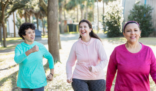istock Three Hispanic woman in park, power walking 1197183267