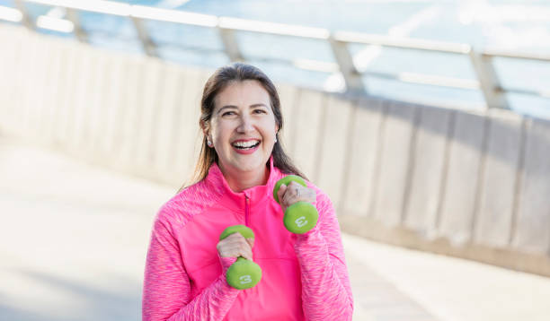 istock Mature Hispanic woman exercising with hand weights 1197183271