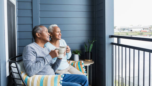 istock Senior couple relaxing on balcony, watching something 1197184494
