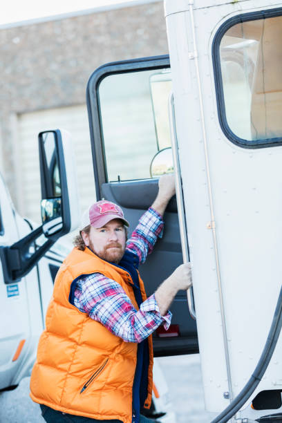 istock Trucker driver climbing into his semi-truck 1197185494