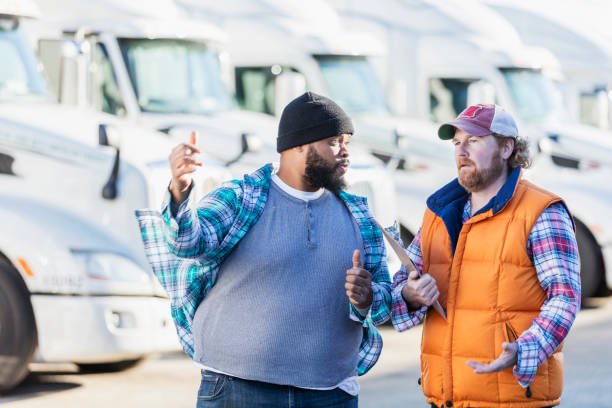 istock Truck drivers with fleet of semi-trucks 1197185708