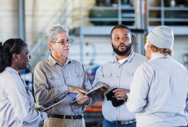 istock Workers in repair shop having a meeting 1197186984