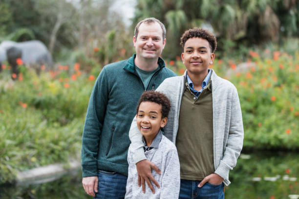 istock Father and mixed race sons standing outdoors 1197187850