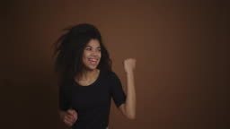 Beautiful Funny African American Girl Dancing Against Brown Wall Background Stock Video - Download Video Clip Now - iStock Beautiful Funny African American Girl Dancing Against Brown Wall Background Stock Video - Download Video Clip Now - iStock