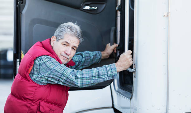 istock Trucker driver climbing into his semi-truck 1197190168