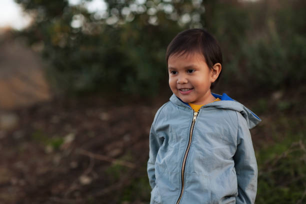 istock A hispanic young boy wearing a jacket and enjoying a day in the wilderness. 1197191960