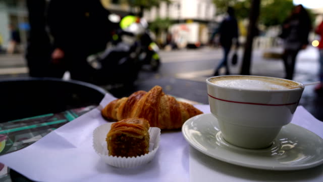 Cup of fresh hot coffee and traditional French croissant