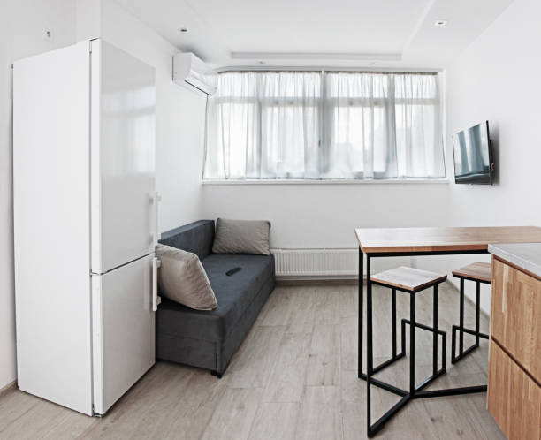 istock oak kitchen with a table with a sofa, air conditioning and a window in the style of Scandinavian design in the afternoon interior, 1197192091