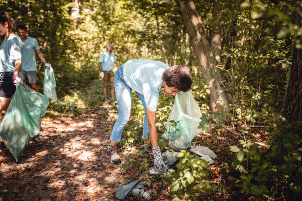 istock Mixed Race Environmental Protector Collecting Trash at Park 1197196829