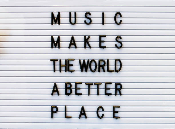 Music makes the world a better place concept made by plastic letters on a white board. stock photo