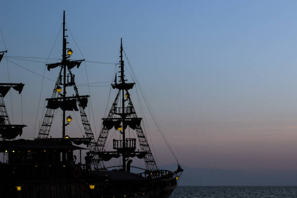 istock cruise vacation medieval vintage ship mast dark silhouette shape on twilight blue evening sky background after sunset with slightly lanterns illumination and empty copy space for text 1197201322