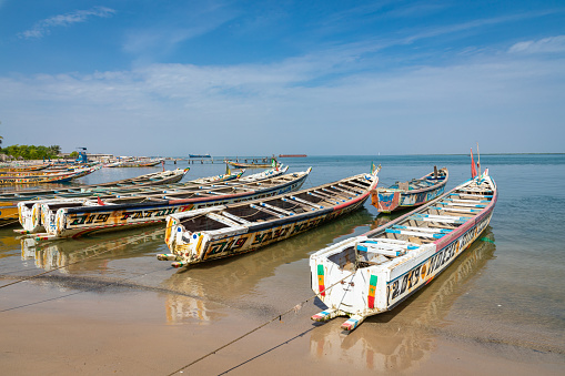 Traditional painted wooden fishing boat in Djiffer, Senegal. West Africa.