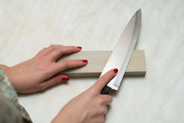knife, whetstone and female hands knife, whetstone and female hands. Woman and male work sharpening photos stock pictures, royalty-free photos & images