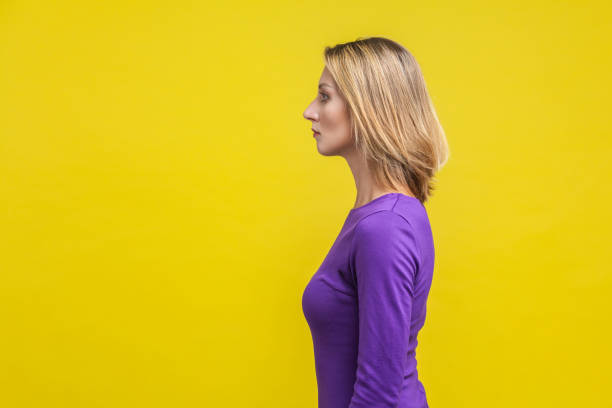 istock Side view of young confident businesswoman looking with serious smart expression. isolated on yellow background 1197204108