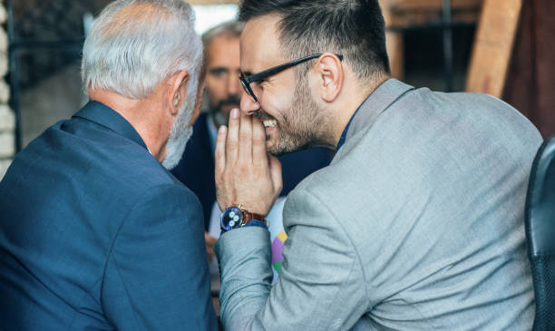 Business colleagues whispering on a meeting