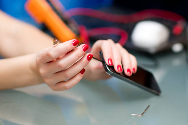 istock female hands repair smartphone, closeup 1197204188