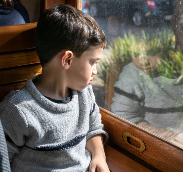 istock Child watching through the closed window the steam train ride (Photo 1). 1197205254