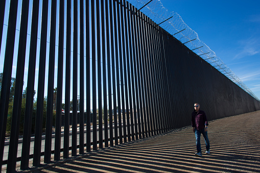 Calexico, CA: Man Walks Past New US-Mexico Border Barrier