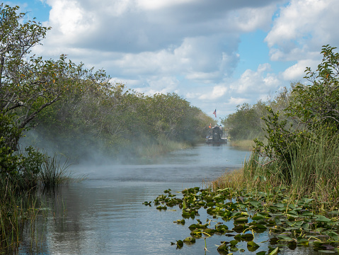 Air boat exhaust and wake with another air boat in the channel at Everglades National Park, Florida, USA