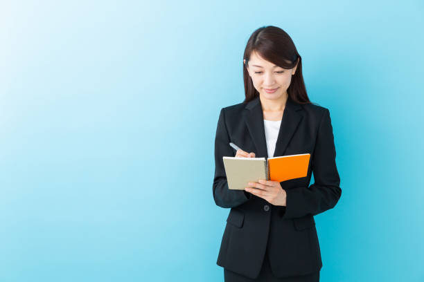 istock asian woman who fills out a notebook 1197213039