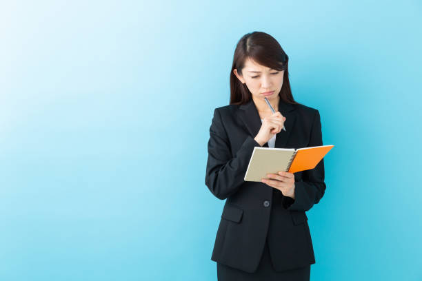 istock asian woman who fills out a notebook,think, 1197213048