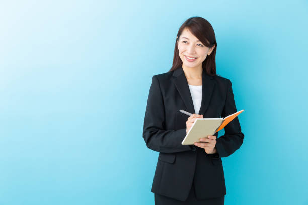 istock asian woman who fills out a notebook 1197213104