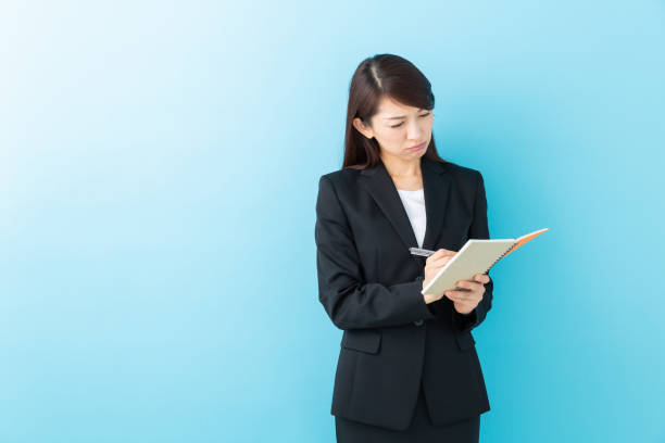 istock asian woman who fills out a notebook,think, 1197213670