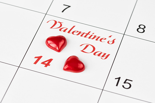 Two red hearts on the calendar with the inscription Valentine's Day. Background for a greeting card for Saint Valentine's Day ore wallpaper