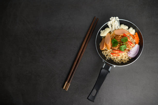 istock Still life with noodles in a pan and chopsticks. Top view. 1197219600