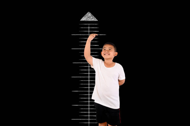 istock The boy measured the height with the blackboard 1197220462