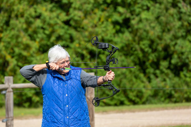 istock Senior Woman Practicing Archery at Outdoor Range 1197221542