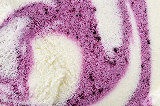 Vanilla and blueberry violet mixed ice-cream texture or background. Top view. Macro shot