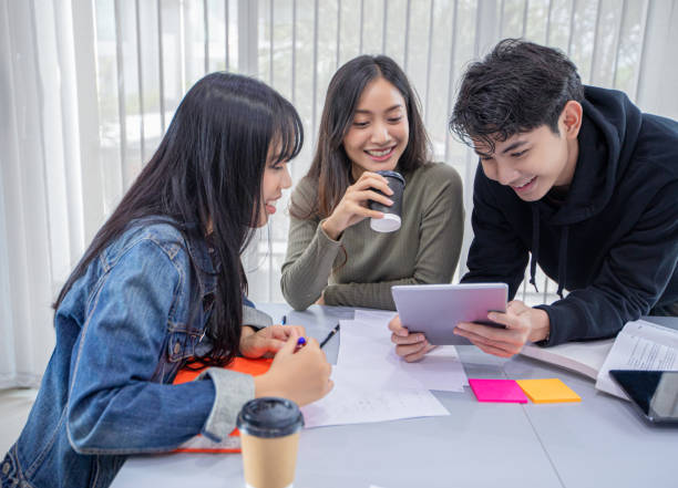 istock Group Students Smile and have fun and using tablet It also helps to share ideas in the work and project. And also review the book before the exam 1197224170