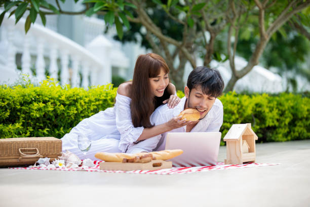 istock Happy Romantic Couples lover talking and drinking wine while having a picnic at home 1197224210