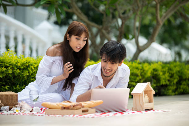 istock Happy Romantic Couples lover talking and drinking wine while having a picnic at home 1197224216